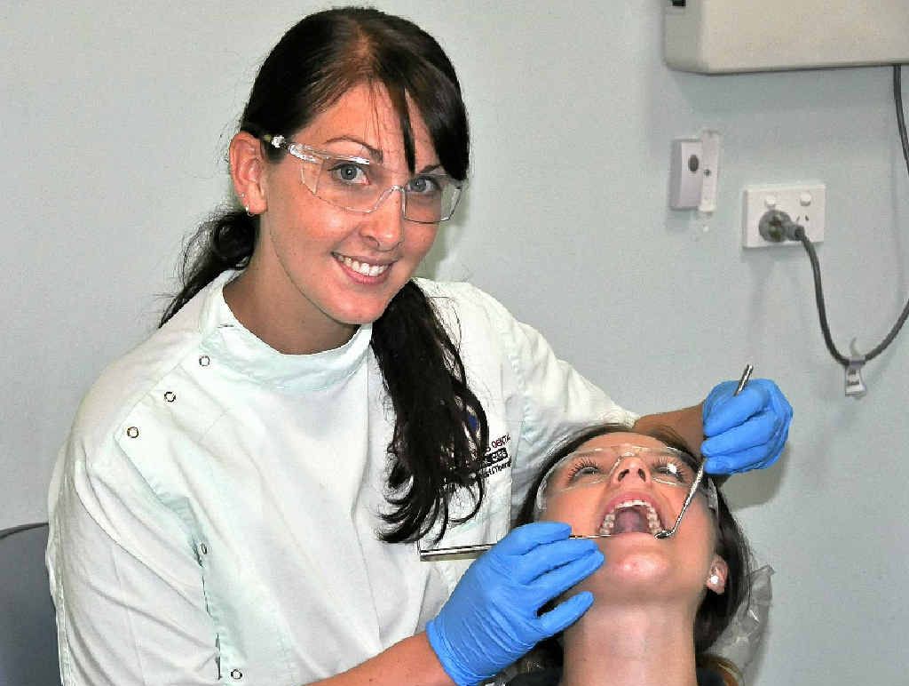 SAY AHHH: Southern Downs Dental hygienist Sarah Geisel has returned to work at her family’s clinic, aiming to follow in her father’s footsteps as a dentist. SAY AHHH: Southern Downs Dental hygienist Sarah Geisel has returned to work at her family’s clinic, aiming to follow in her father’s footsteps as a dentist.